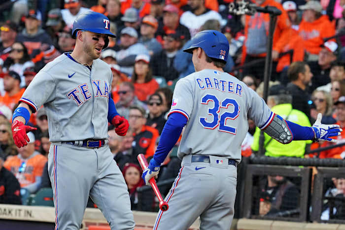 Texas Rangers designated hitter Mitch Garver celebrates with Evan Carter after hitting a grand slam in the third inning against the Baltimore Orioles during Game 2 of the ALDS at Camden Yards.